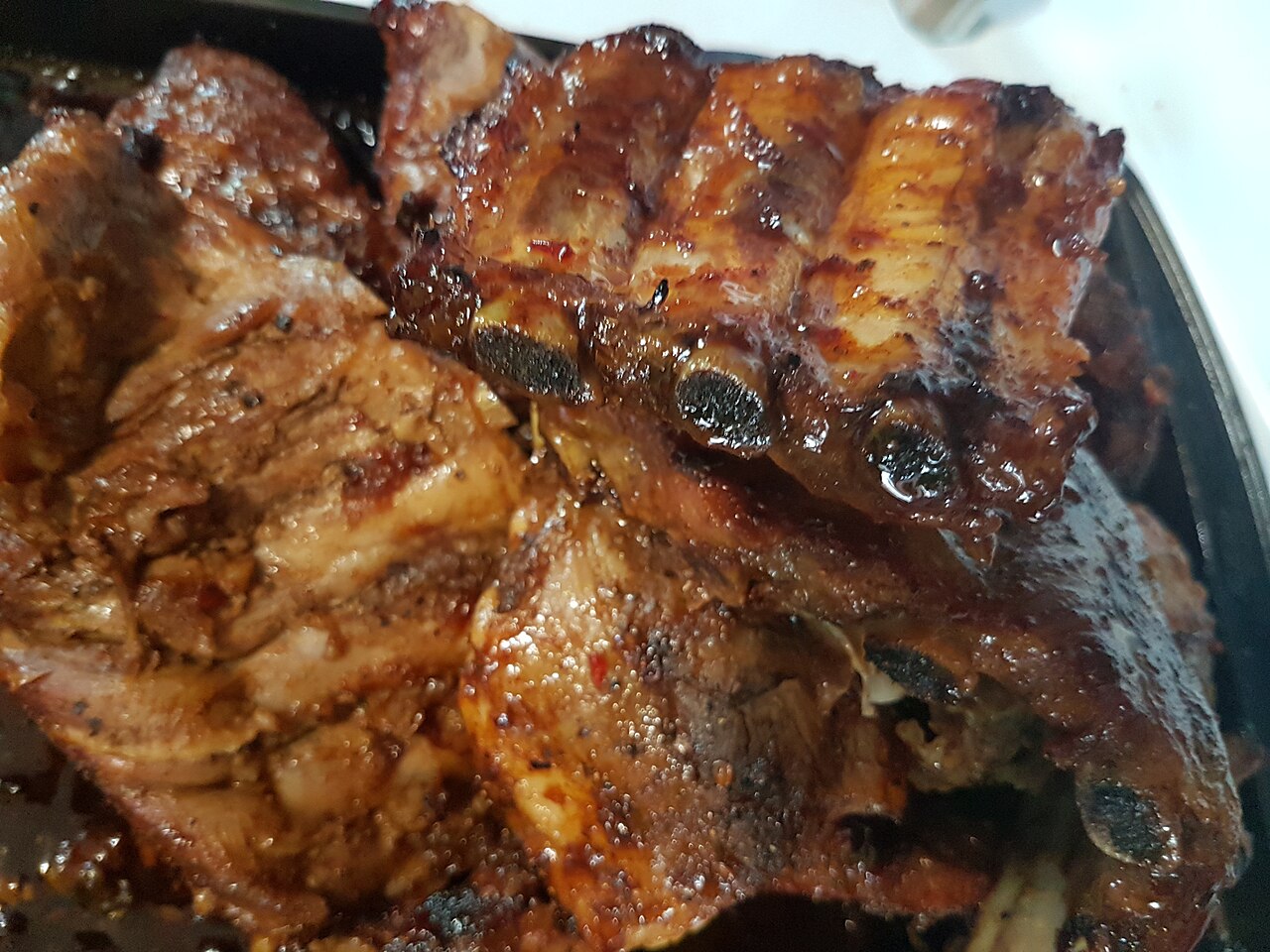 Sliced BBQ ribs with a glossy sauce finish