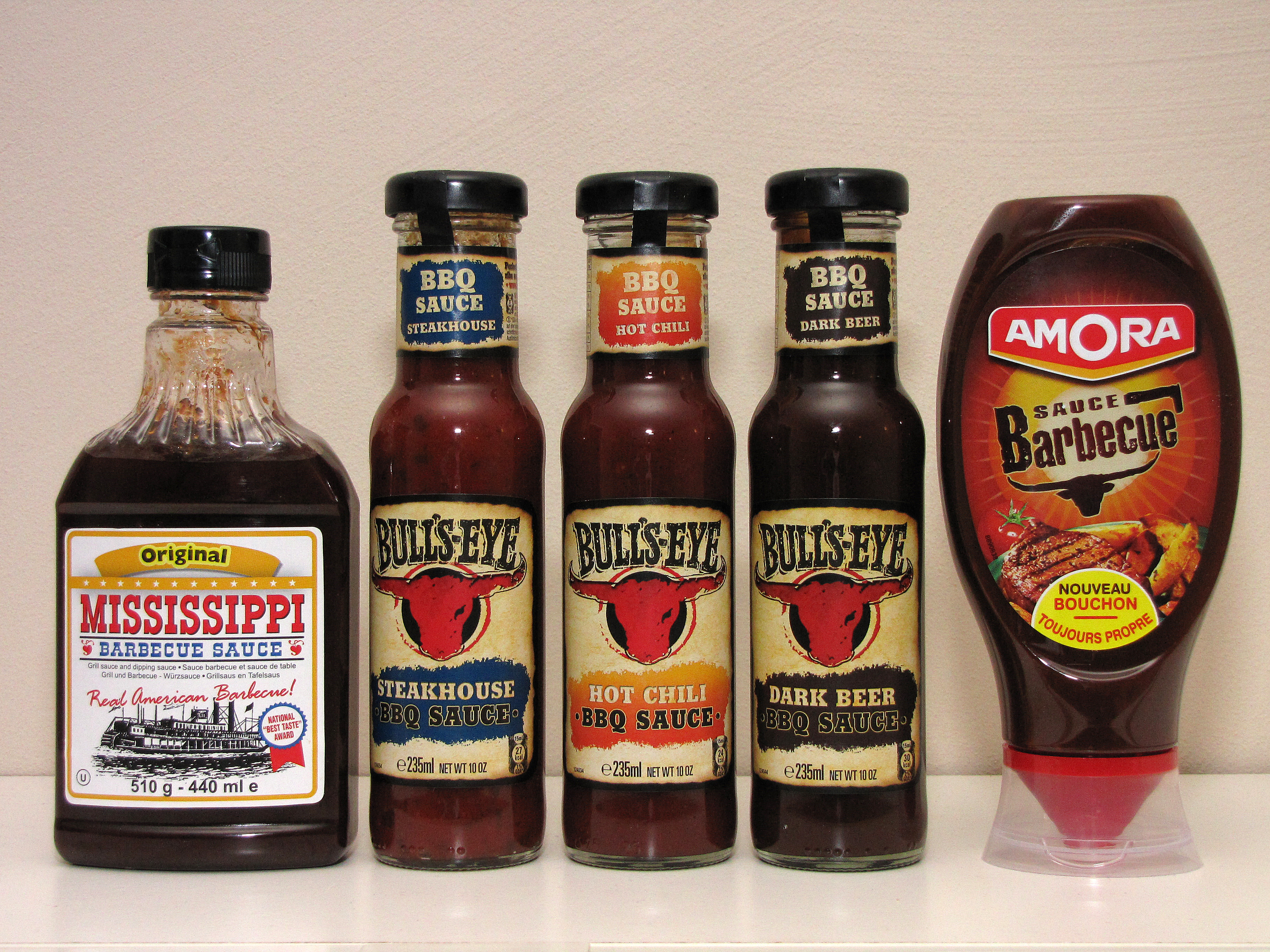 BBQ sauce bottles lined up to compare flavor and heat levels.